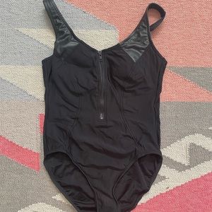 Chic black one piece with faux leather detail